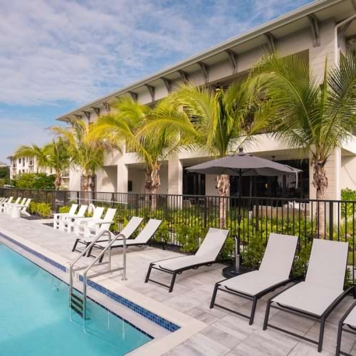 Resort-style swimming pool with lounge seating