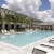 pool area with reclining seats and landscaping