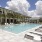 pool area with reclining seats and landscaping