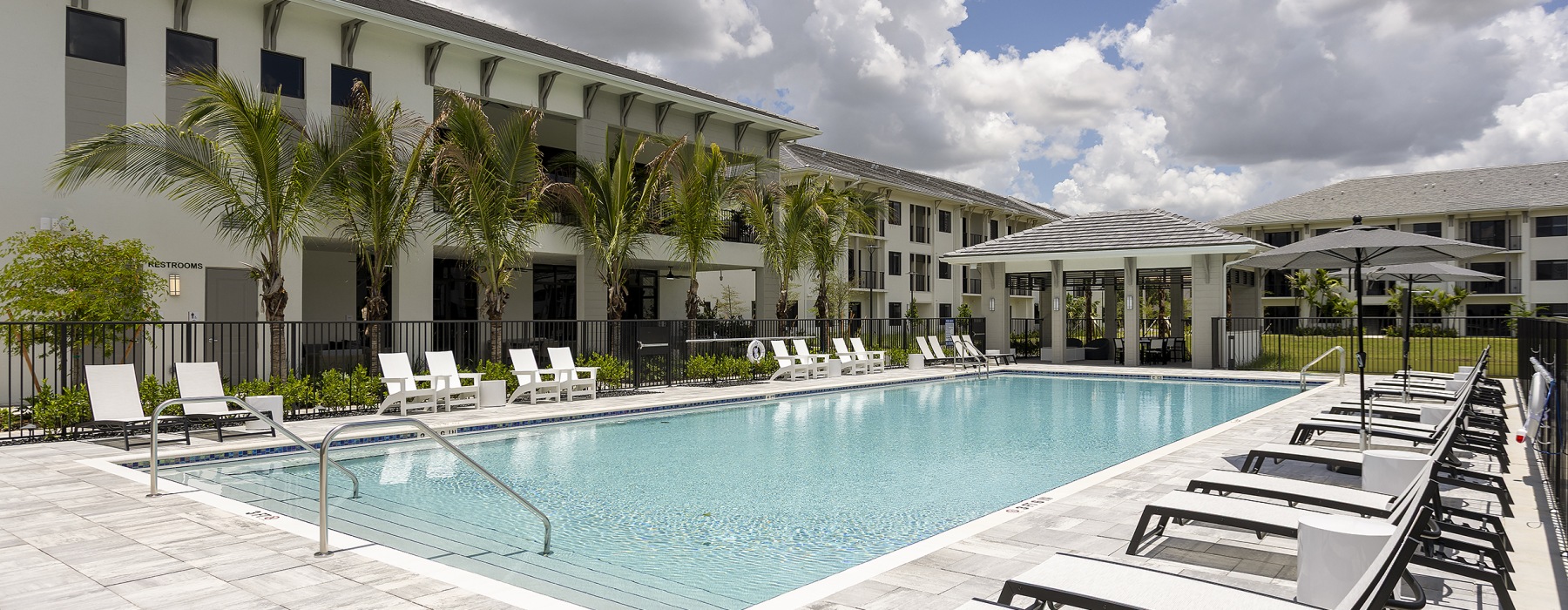 blue pool with lounging chairs