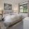 bedroom with ample space around the bed and bright lighting